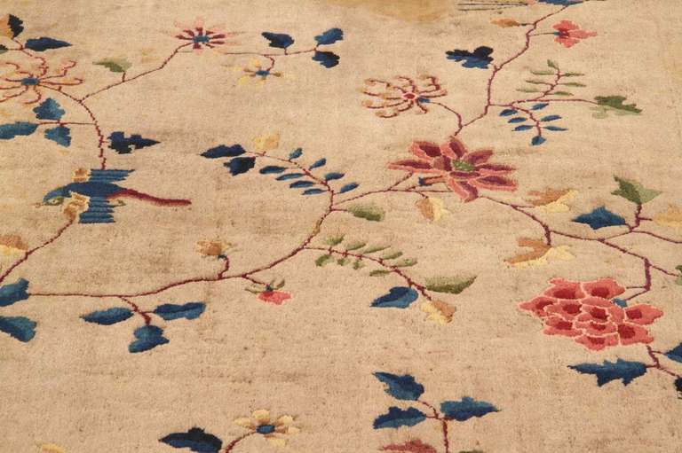 Beautiful wool carpet hand-knotted in China mainly during the 1920s and 1930s. Colors are bright and bold. Designs are simple but very decorative: a thick border with floral arrangement stretched toward the centre of the rug.