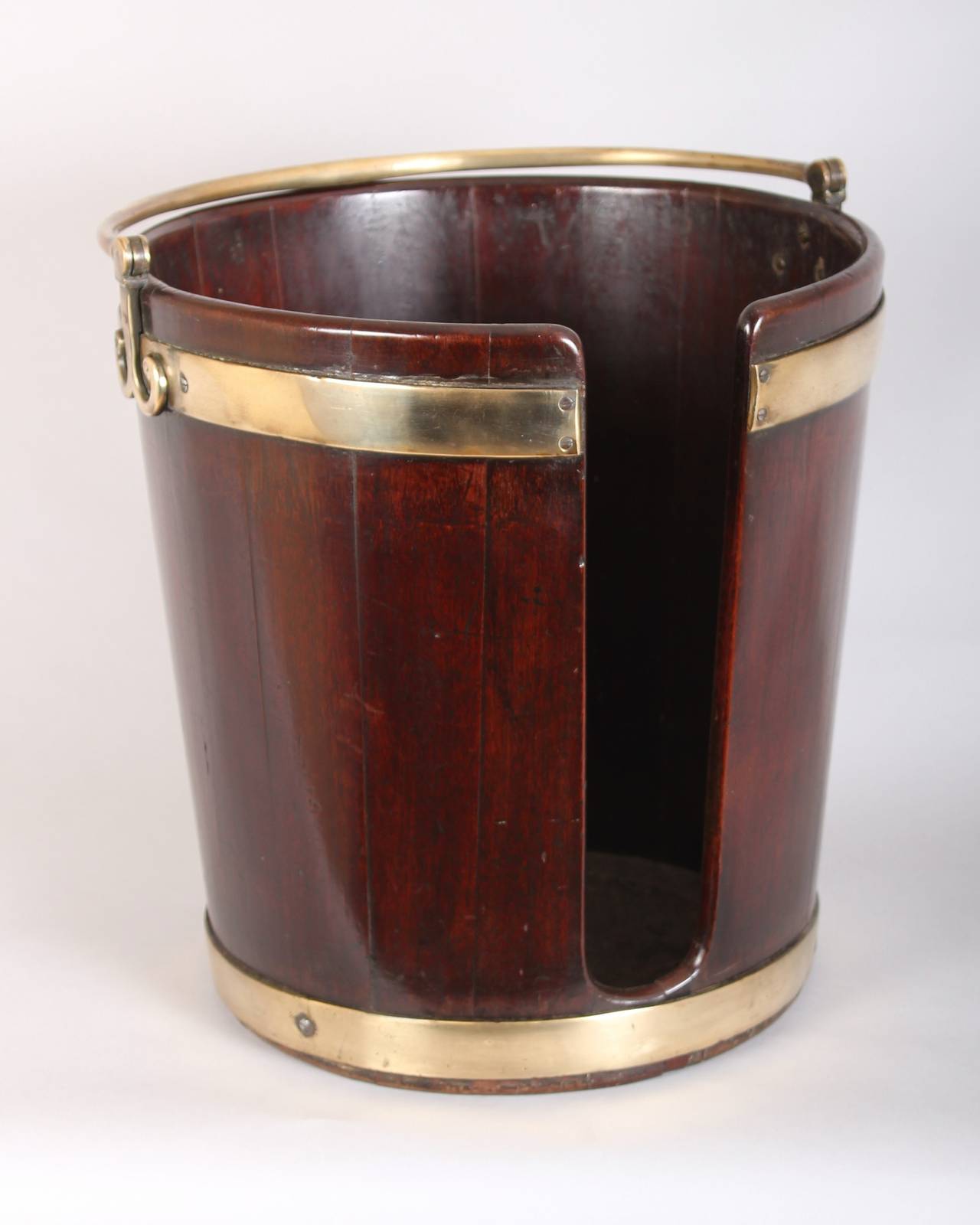 George III period mahogany plate-bucket of coopered construction with two brass bands and a swing-handle.