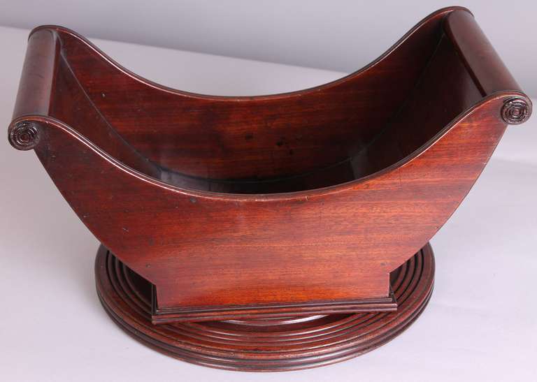 Rare George III period mahogany 'Lady-Susan' Cheese-Coaster; the boat-shaped cradle swivelling on a circular turned and reeded base. Circa 1800
Diameter 12 inches