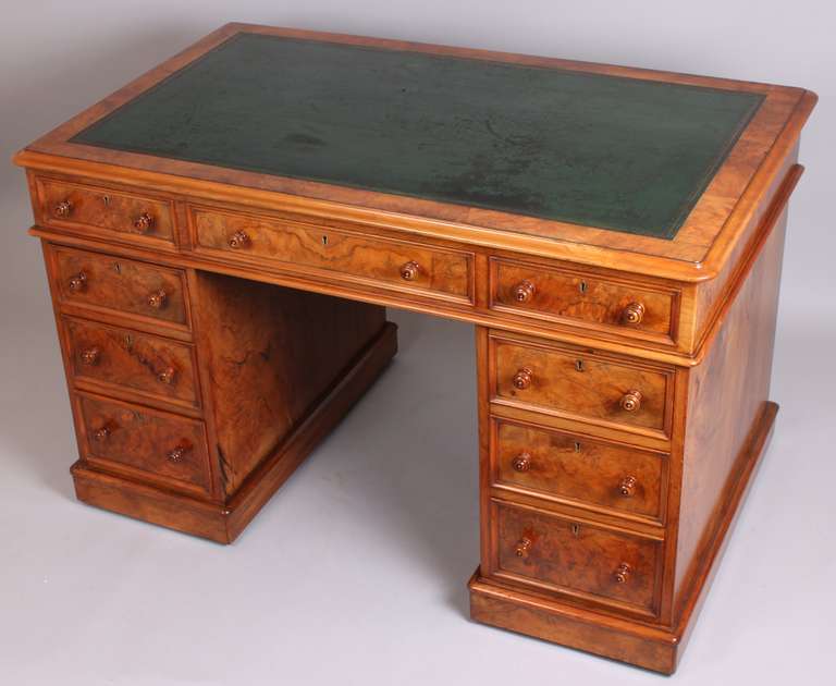 High quality figured walnut kneehole desk stamped James Winter & Sons, 101 Wardour Street, Soho, London, circa 1835; the top with rounded corners, lined in old dark green leather; the mahogany lined drawers with moulded edges and original turned