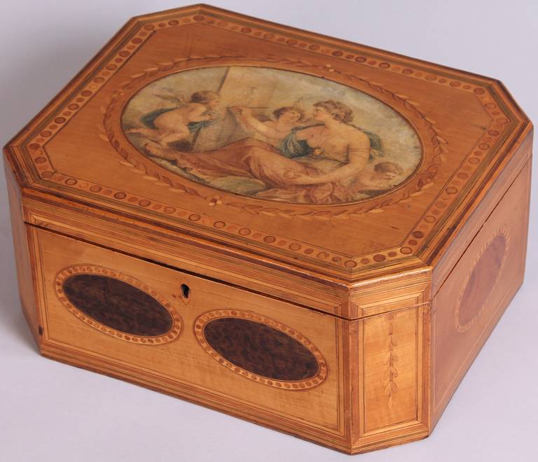 Fine George III period satinwood and marquetry jewellery box in the manner of Thomas Sheraton; the top with a coloured oval mezzotint in the style of Angelica Kaufman within an inlaid laurel wreath and an outer border of pellets and fine