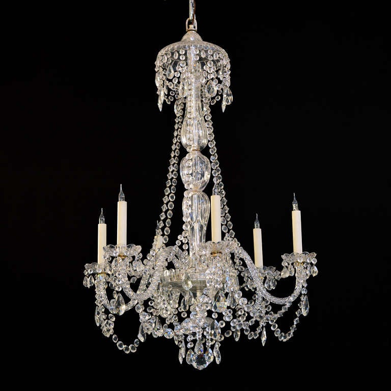 Three George III style cut glass six light chandeliers, the domed corona hung with faceted drops and swags, with cascades surrounding faceted multi-baluster central stem issuing six moulded s-scroll arms each with faceted scallop-edged drip-pans