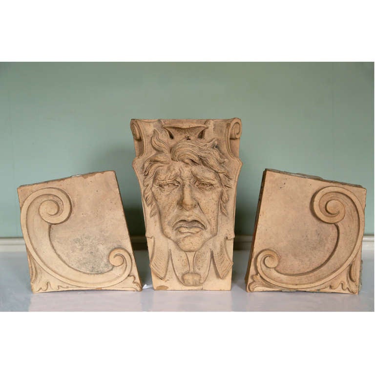 An artificial stone keystone depicting Tragedy, modelled in high relief, flanked by two further elements modelled with c-scrolls.

Keystone dimensions: h 49.5cm, w 31.5cm, d 37.5cm
C-Scroll dimensions: h 35.5cm, w 34.5cm, d 13.5cm

Available to