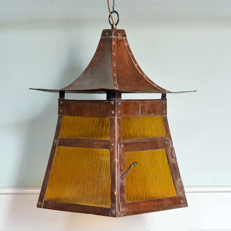 A copper Arts and Crafts Lantern, with amber glazing.

Available to view at Brunswick House, London.