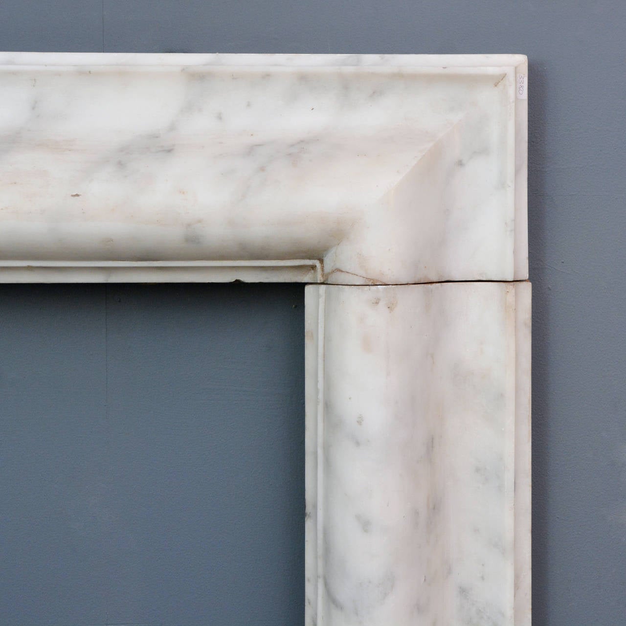 A Carrara marble bolection fire surround, nineteenth century, with typical ogee moulded frieze and jambs, on square footblocks.

Available to view at Brunswick House, London.

118.5cm high, 139.5cm wide