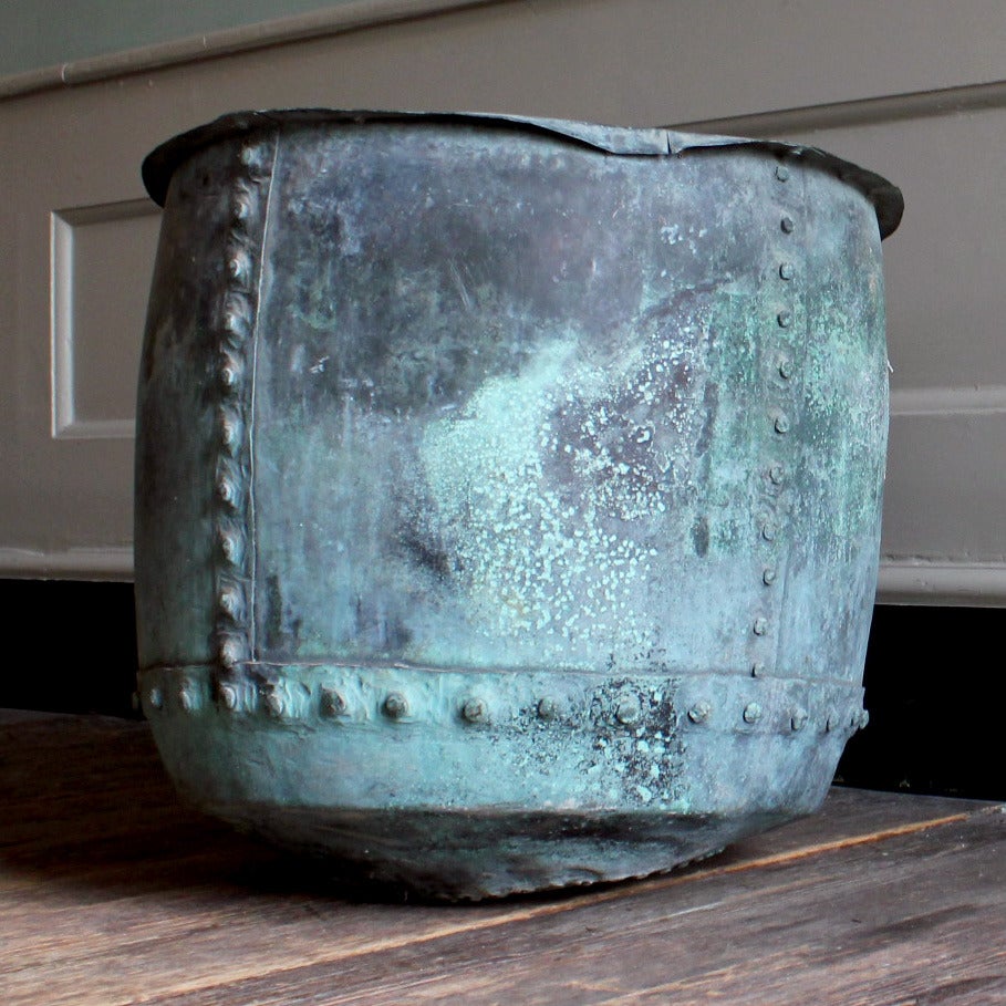 A nineteenth century copper vat, riveted, with well patinated exterior and patched repairs.

Available to view at Brunswick House, London.

Diameter 55cm, height 52cm.