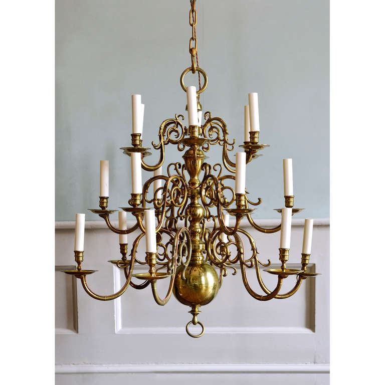 A brass eighteen light chandelier, late nineteenth century, in the Dutch style, with three graduated tiers of six branches.

Available to view at Brunswick House, London