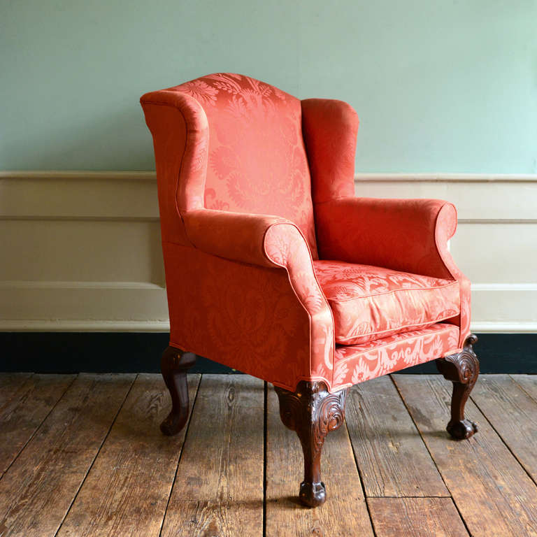 A George II style armchair, the front cabriole legs carved with acanthus, scrolled ears and claw and ball feet, re-upholstered in silk damask formerly hung in the Great Gallery of the Wallace Collection, Manchester Square, London. 

Available to
