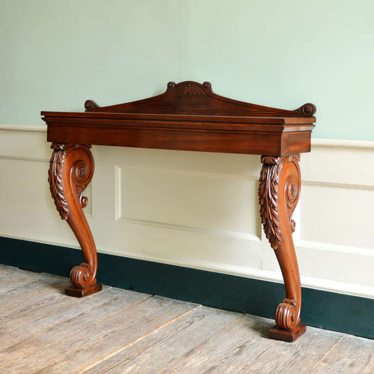 A Regency mahogany console table, the rectangular top above acanthus carved volute scrolled supports.

Available to view at Brunswick House, London.