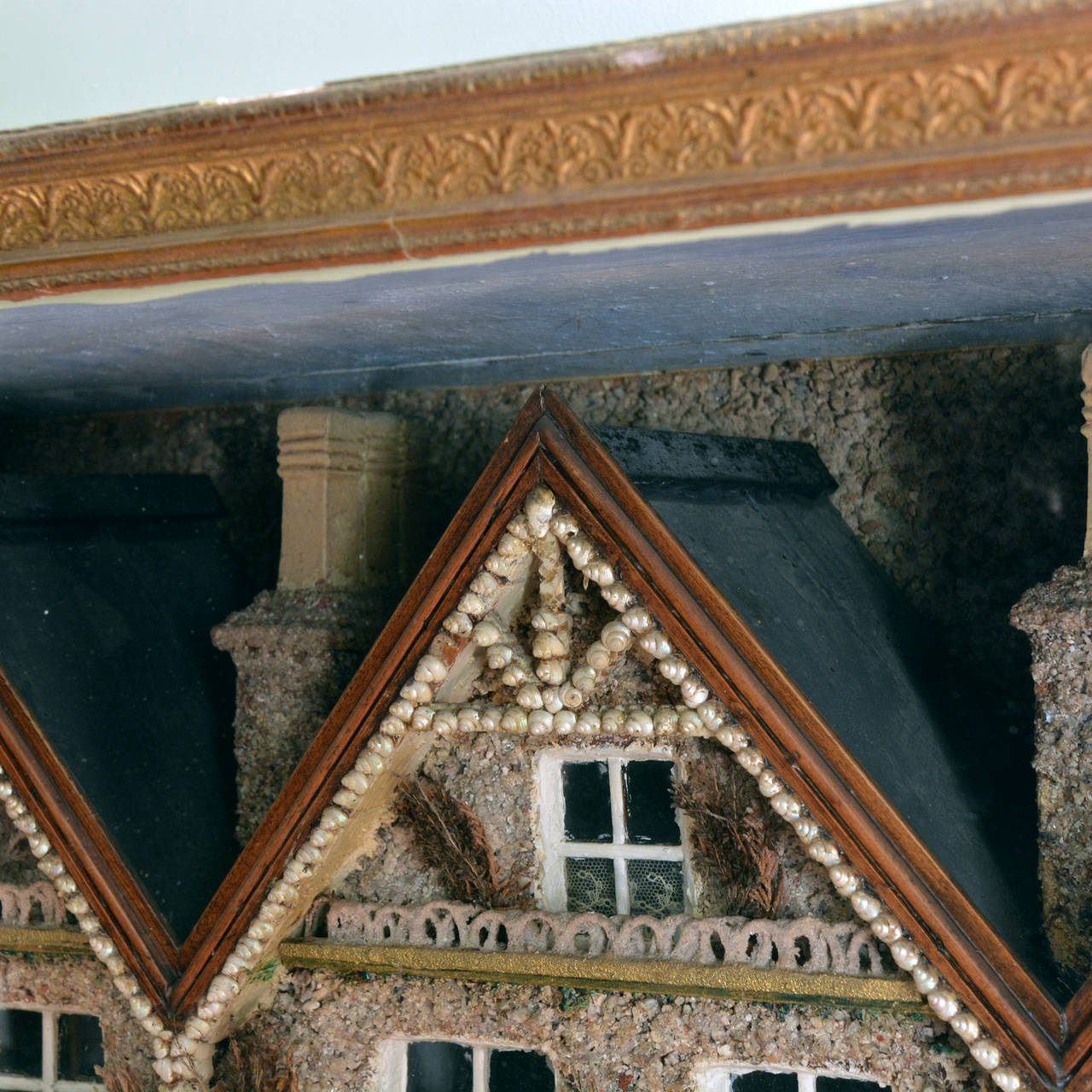 A large Victorian shell diorama depicting a row of terraced houses, in stained pine case.

Available to view at Brunswick House, London.

Height 77.5cm, width 96.5cm, depth 42.5cm