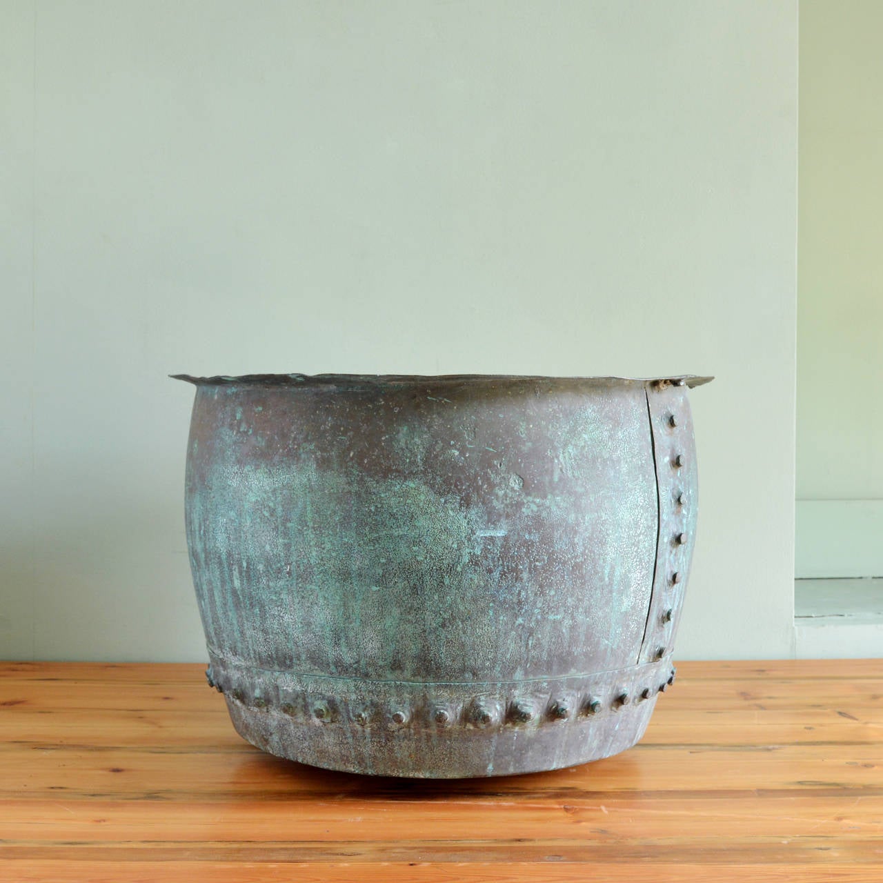 A nineteenth century riveted copper vat with well weathered verdigris exterior.

Available to view at Brunswick House, London.

52cm high, 32cm diameter.