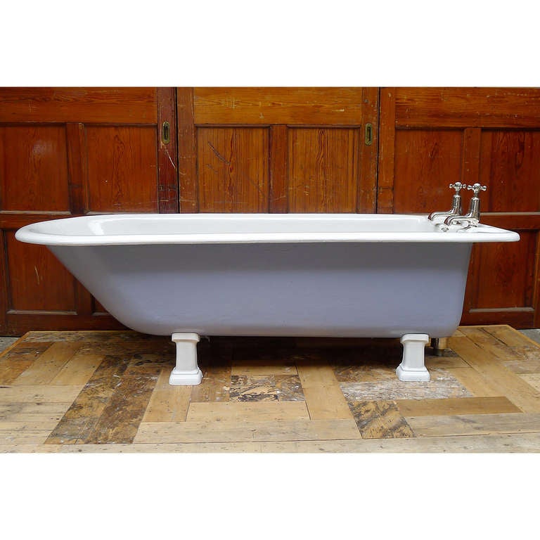 A large Edwardian cast iron bath with exposed columnar plunger and taps restored and plated in nickel, the body in vitreous enamel, on pillar feet.

'Bolding, London'.

Available to view at Ropewalk, London.