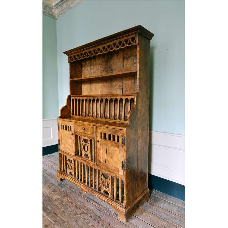 A nineteenth century Poplar coop dresser, Irish, of stepped form, the moulded cornice with fret cut frieze on two shelves with an arrangement of hinged compartments, cupboards and drawers below, on bracket feet.

Available to view at Brunswick