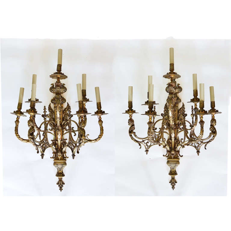 A pair of gilt metal seven light wall appliques, nineteenth century, each acanthus clasped scrolling arm with pierced and foliate cast drip pan.

Available to view at Brunswick House, London.