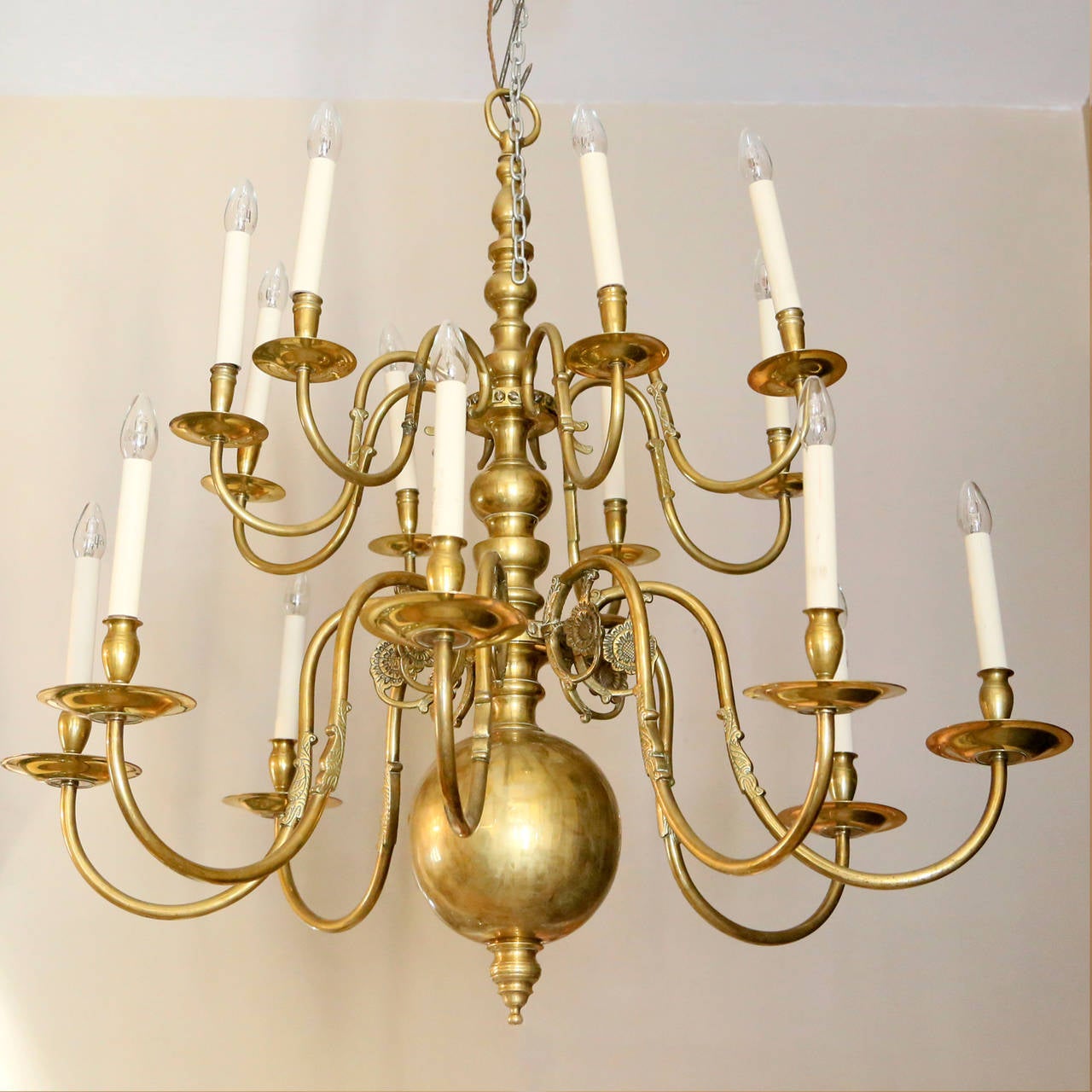 A sixteen light brass Flemish style chandelier, the knopped stem issuing two tiers of scrolled branches.

Available to view at Brunswick House, London.

Height 105cm, width 102cm.