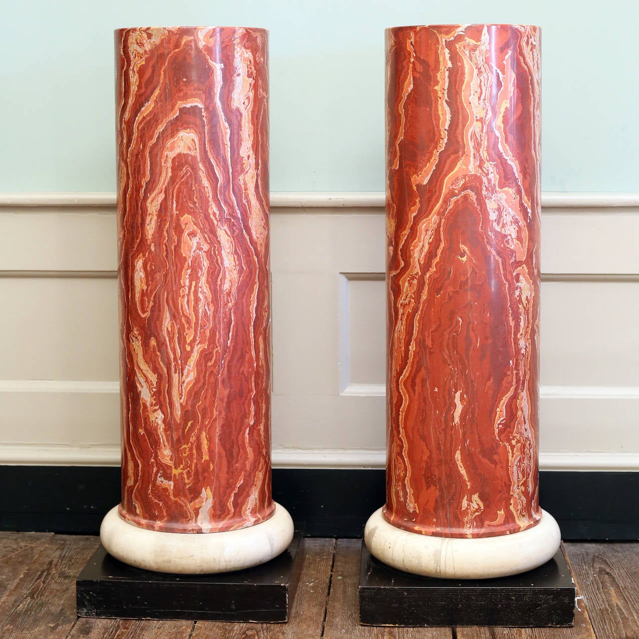 A pair of scagliola pedestals on plinth bases, in imitation of Red Onyx, twentieth century