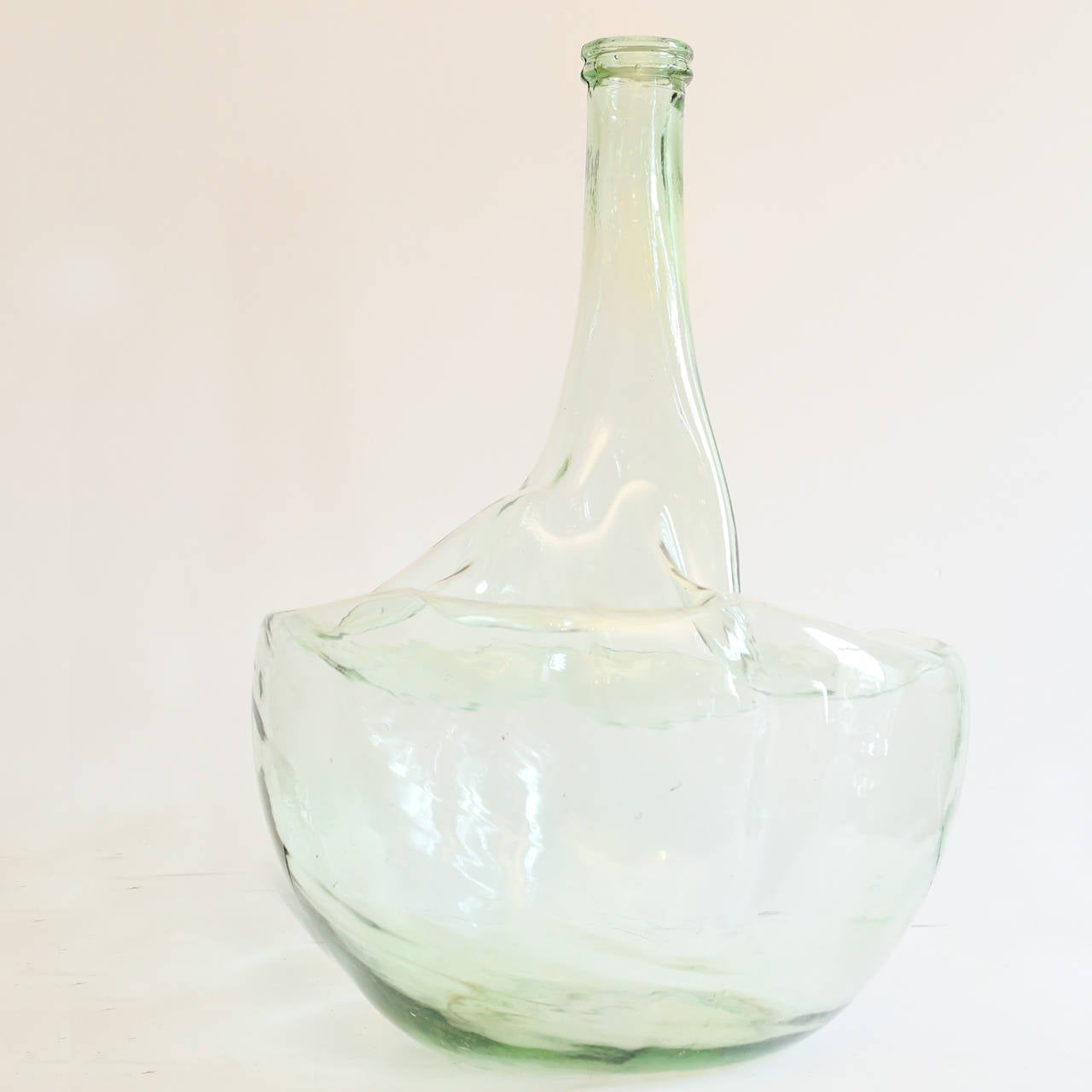 A large slumped glass fermentation vessel, suitable for use as a vase.

Available to view at Brunswick house, London.

Height 66cm, width 42cm.
