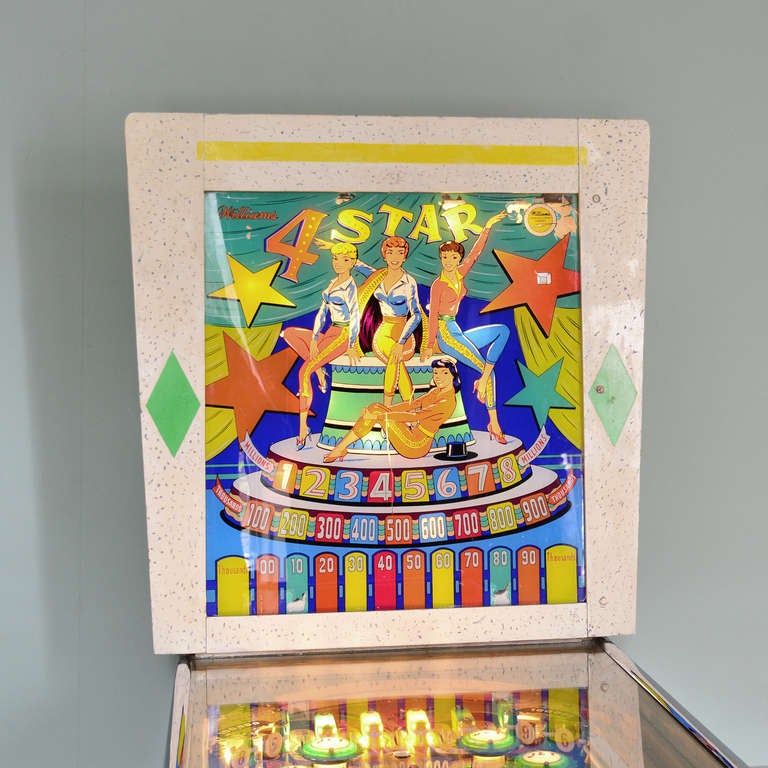 A late 1950's American electro-mechanical pinball machine on chrome plated legs, 'Williams 4 Star'. Restored and in full working condition.

The artwork for this electro-mechanical pinball is by the celebrated coin-operated machine art specialist
