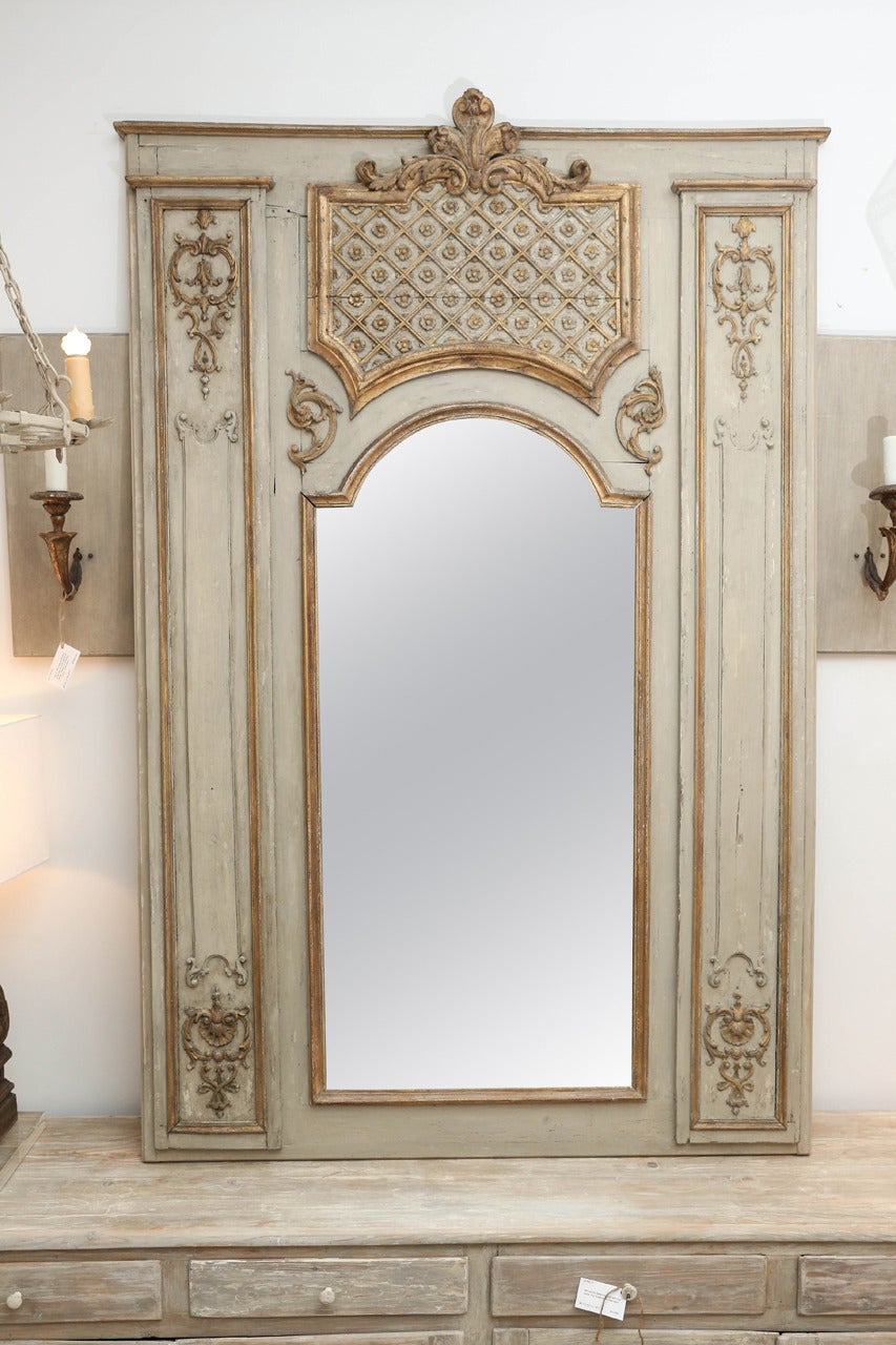 Large 18th century trumeau mirror, hand-carved with bois doré detail and later paint and mirror.