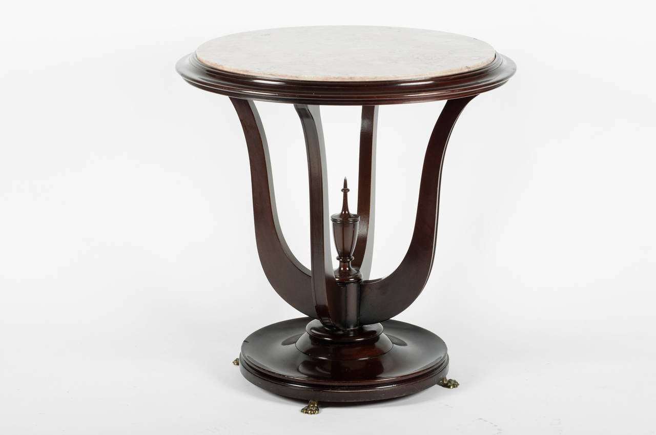 A marble-top table with urn finial in base, with a pink marble top
Measures: 27