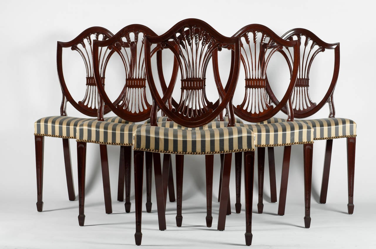 Vintage set of six mahogany wood shield chairs with hand-carved spindles. Excellent condition. Each chair measure: 35 inches high X 19 inches length X 17 inches width.
  