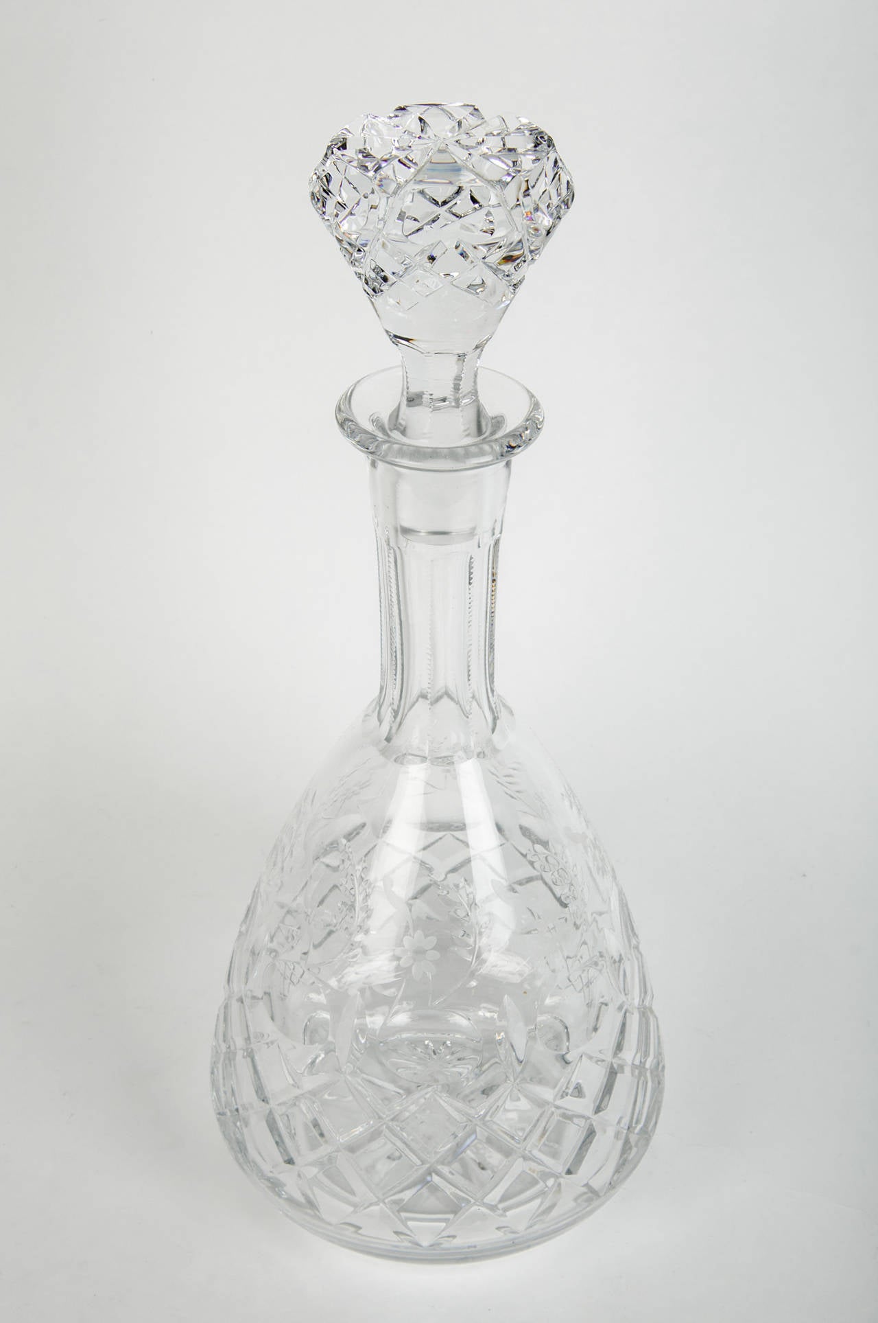 An antique French crystal cut decanter with crystal cut lid with etched design.