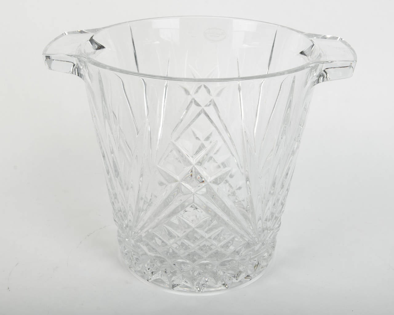 An antique French crystal cut ice bucket with handle.