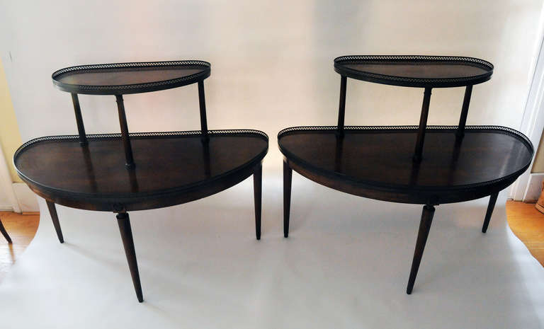 Pair of walnut two-tier demilunes with metal galleries. Measures: Lower shelf, 24