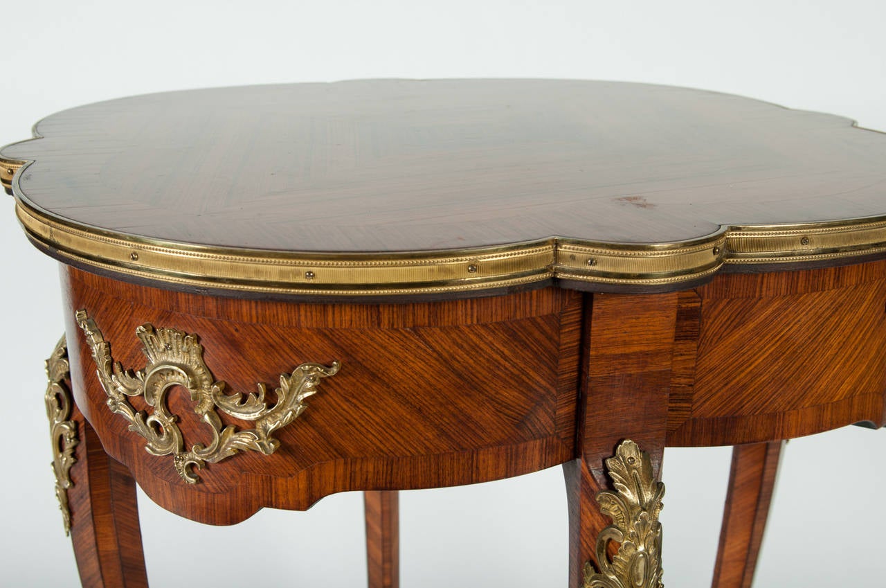 A French inlaid side table with gold bronze mounts. Circa 1930's. Excellent condition. The table measure 28