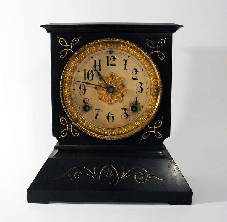 Beautiful antique Ansonia mantle clock made in New York. This gold accented clock is painted black steel with hand painted details. Gold egg and dart border around face.
