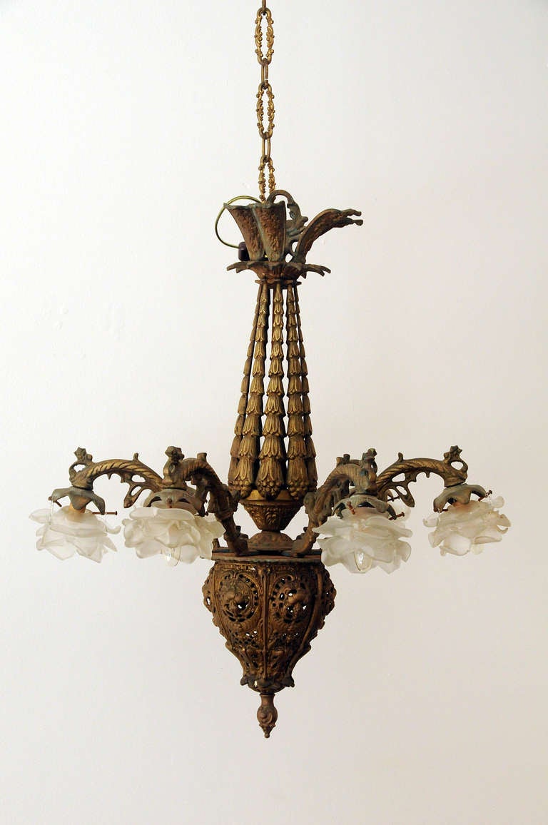 Gothic style chandelier with flower shaped glass lights and brass fret work.