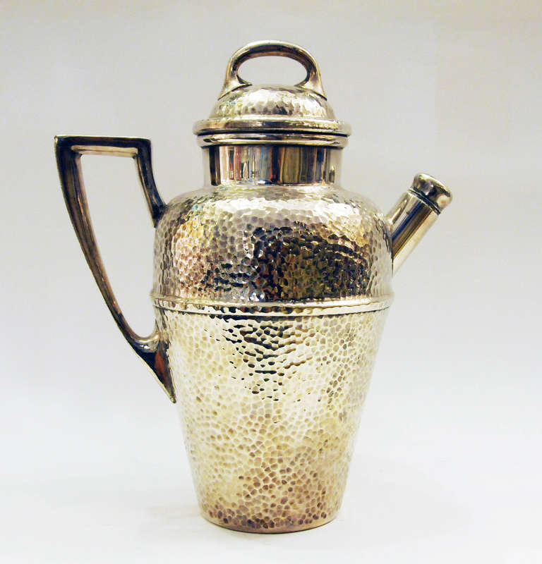 Vintage hammered cocktail shaker with handle and spout with screw cover. Handled lid with attached juicer.
