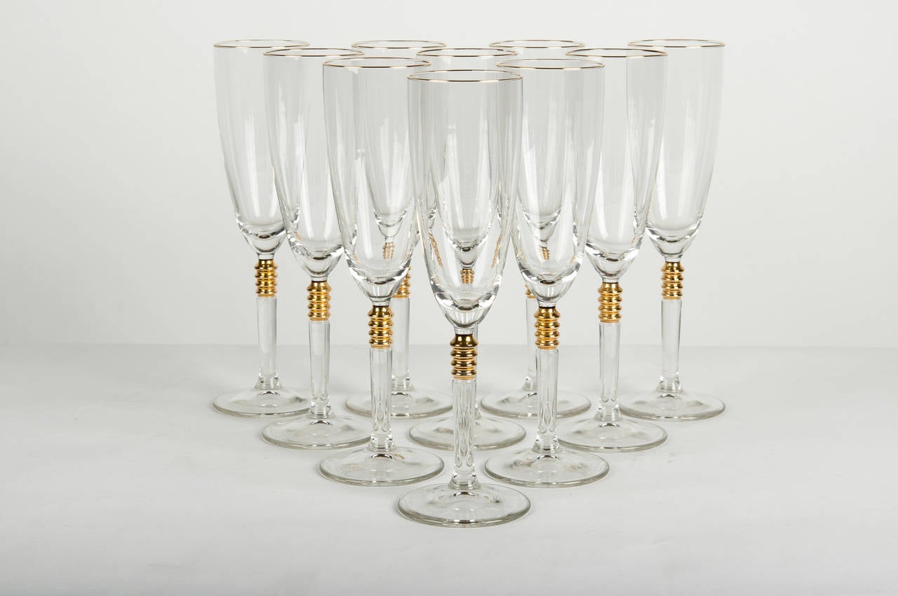 A vintage set of 12 French crystal Champagne glasses with 18-karat gold stem design with a thin gold ban. Excellent condition. The glasses measure 9