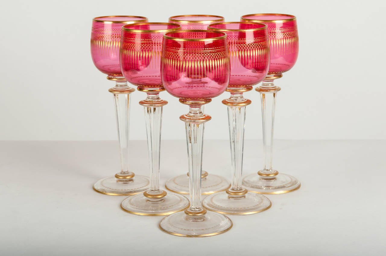 An antique set of six Saint Louis wine crystal glasses with etched gold design. Clear stem with gold trim. Excellent condition.