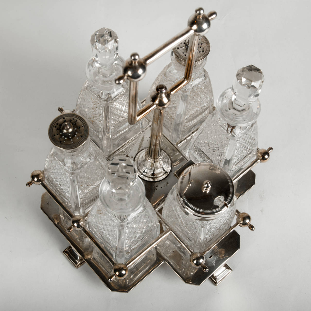 Antique English lead free cut crystal condiment set with silver plate caddie. 12-piece set.