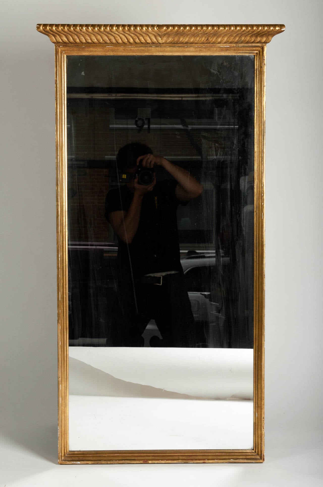 A Vintage wooden Wall Mirror in a gold gilt frame with a detachable Carved Crest.