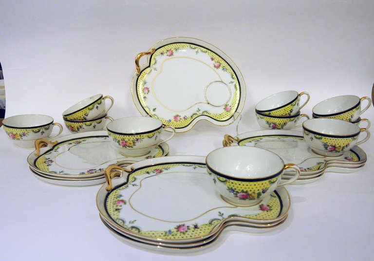 Service for 10 luncheon or tea set with multicolored floral design and gold trim. Marked 
