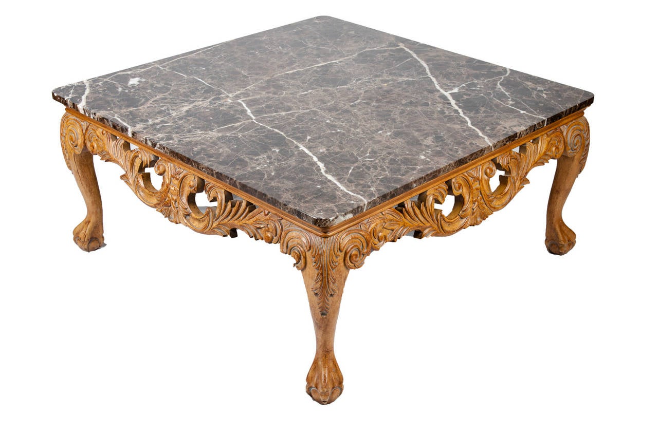 Vintage Italian marble-top coffee table with a heavily carved base. The coffee table is in excellent condition. It measures 40