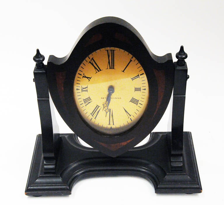 Antique Seth Thomas clock in perfect working condition. The face swivels on mahogany wood with oak inlay stand. Made in USA.