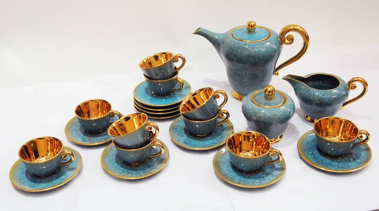 Gorgeous glazed tea set with beautiful turquoise glaze and 22k gold trim. Service for 10. Signed on the bottom. 