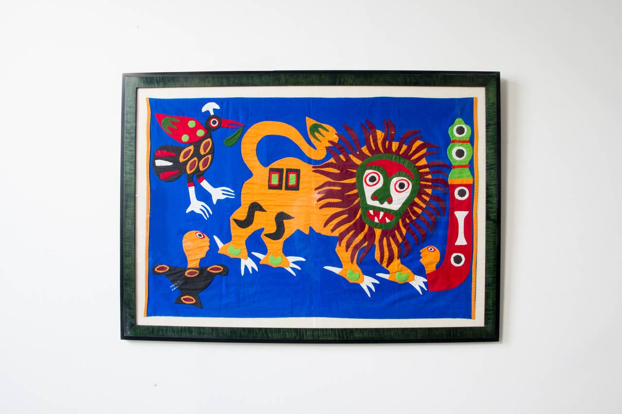 A bright and vibrant West African Dahomey Applique on a primary blue background with orange trim. A tradition over 300 years old, these appliques were produced by various family guilds, under control of the kings to exhibit their splendor. To be