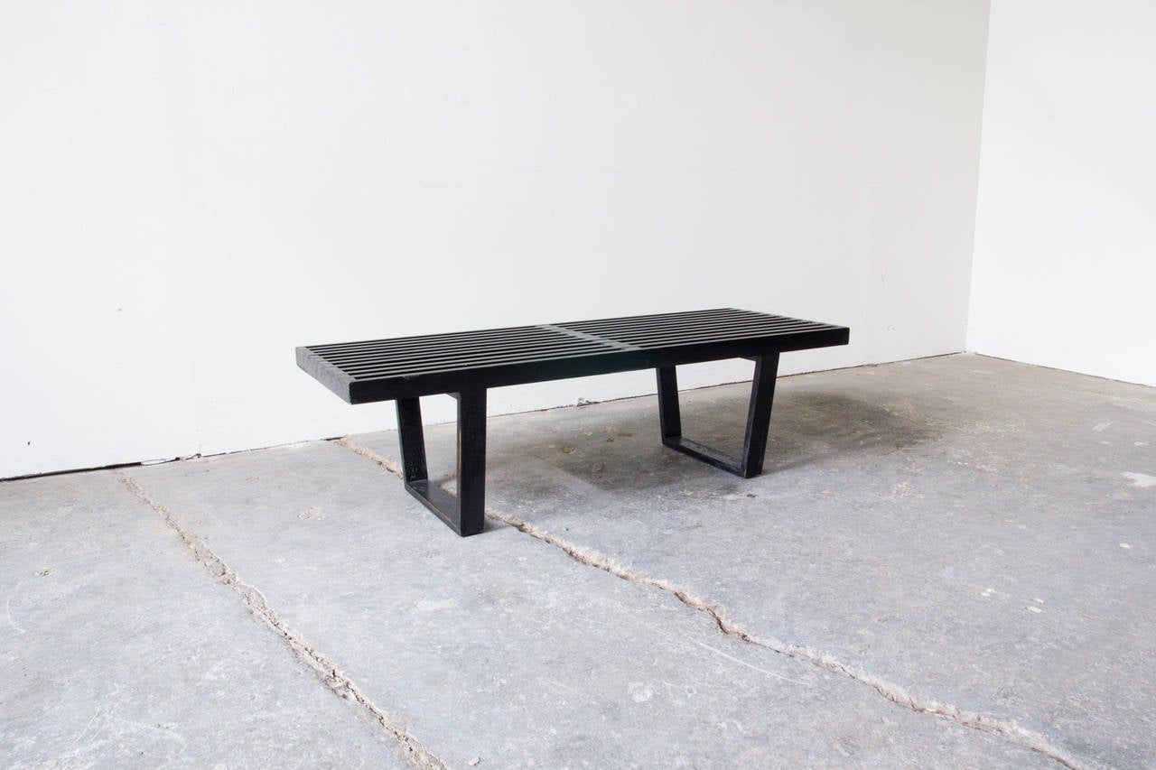 A classic 4-foot black lacquered slat bench by George Nelson for Herman Miller. This piece can be used as the base for some George Nelson cabinet units, or as seating.