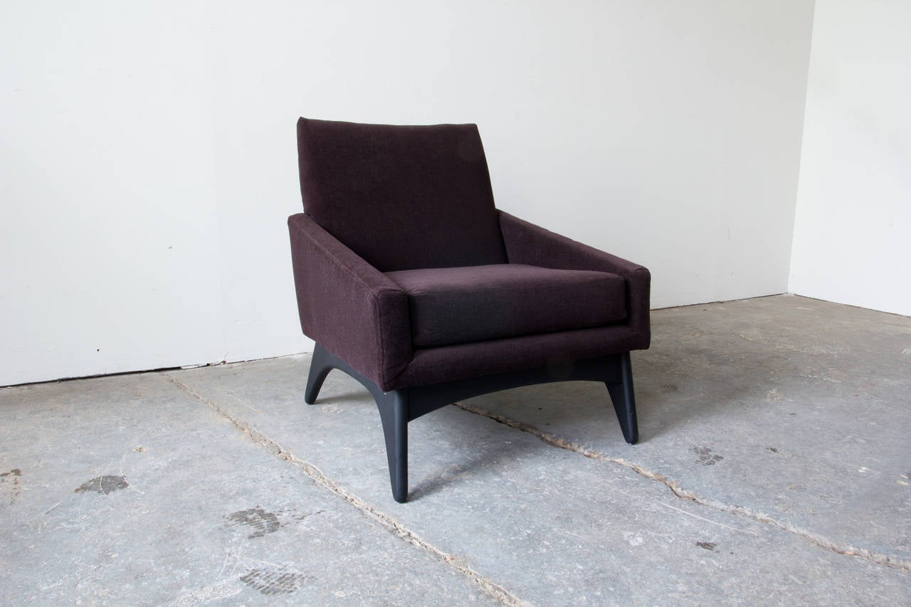 A low and deep lounge chair by Adrian Pearsall for Craft Associates. The organically formed wood legs and rails are painted in a black lacquer. The chair is upholstered in a deep purple wool fabric.