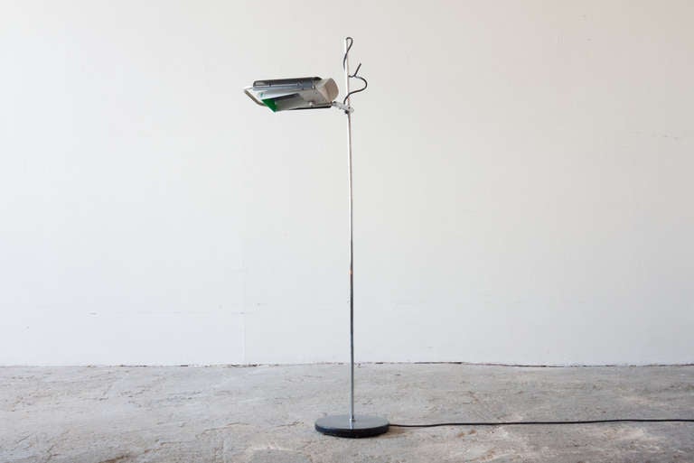 This floor lamp by George Nelson for Koch & Lowy, was Nelson's last lamp design. It culminated many design features developed by Nelson over his career. The light head swivels, twists, raises and lowers along the thin chrome stem. It stands on a