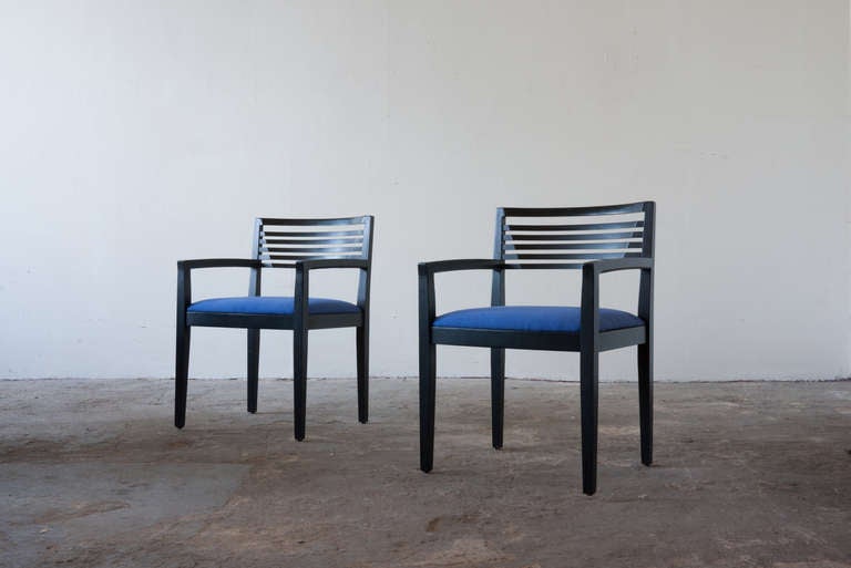 This pair of chairs by Linda and Joseph Ricchio for Knoll Studio has been an instant success, as seen in use by many public spaces. This pair features painted wood and blue upholstery. The contours in the backrest provide centered support while