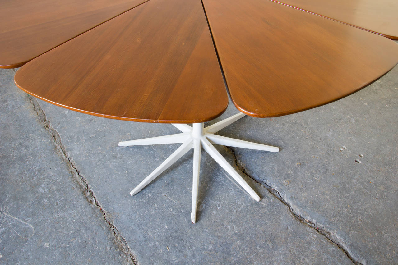 The petal table, by Richard Schultz for Knoll, features an ingenious support structure and eight-point base in aluminum. Eight red cedar 'petals', mounted to the structure, comprise the tabletop.