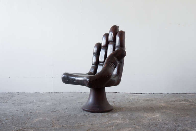 This surrealist hand chair, in the style of Pedro Friedeberg's original, is carved from solid wood. The base is tulip shaped, and the hand is well sculpted and detailed.