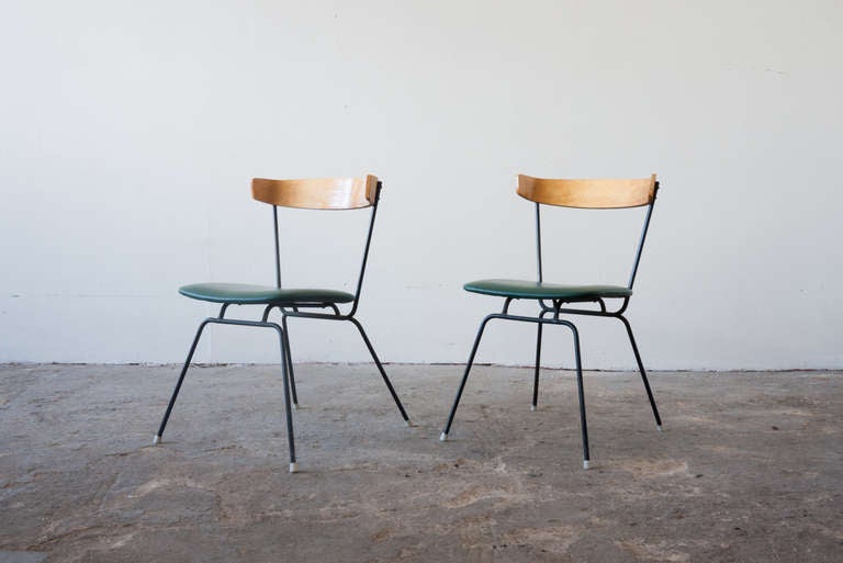 This pair of iron chairs by Clifford Pascoe feature thoughtful lines, and a curved birch backrest. The seat has been recently reupholstered in green leather. This chair was featured in the 1950s by the Museum of Modern Art.