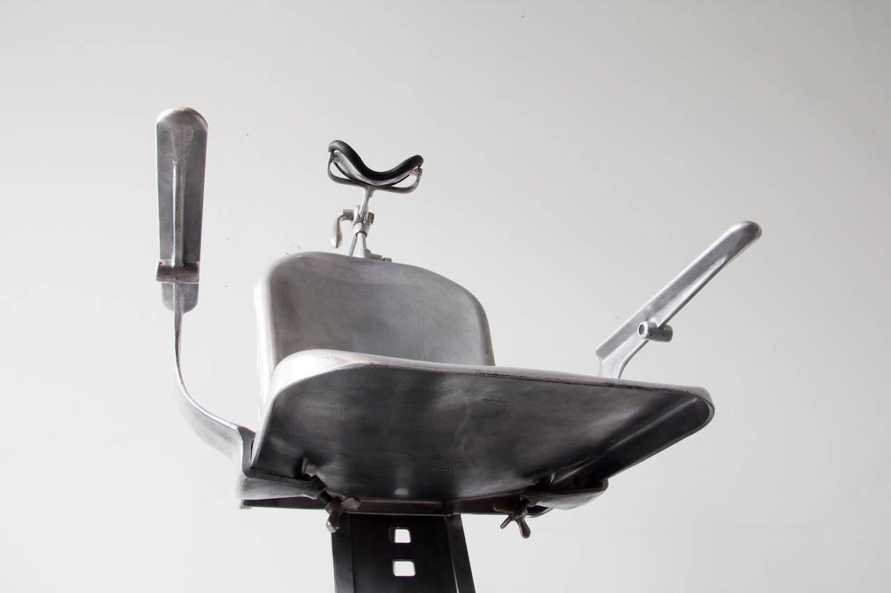 A sinuous and robust U.S. Army field examination chair by S.S. White. Contributing to its sculpted quality is the burnished look of the aluminum, as a result of the direct pouring process (ALCOA). It folds, tilts, raises, lowers and breaks down in