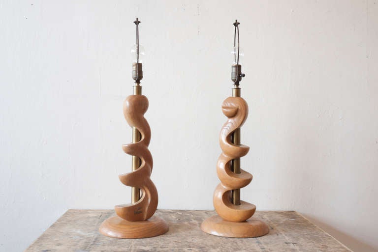 A pair of sculpted wood lamps by Light House Lamp and Shade Co., Los Angeles CA. Wood and lacquered brass. Both lamps have tags, one is worn off a bit.